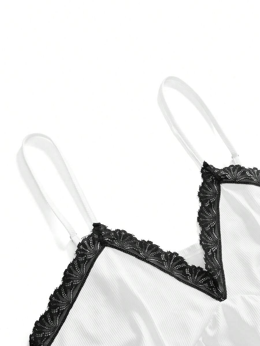 Two-piece ribbed pajama set featuring a lace-trimmed crop camisole top with spaghetti straps and matching shorts.