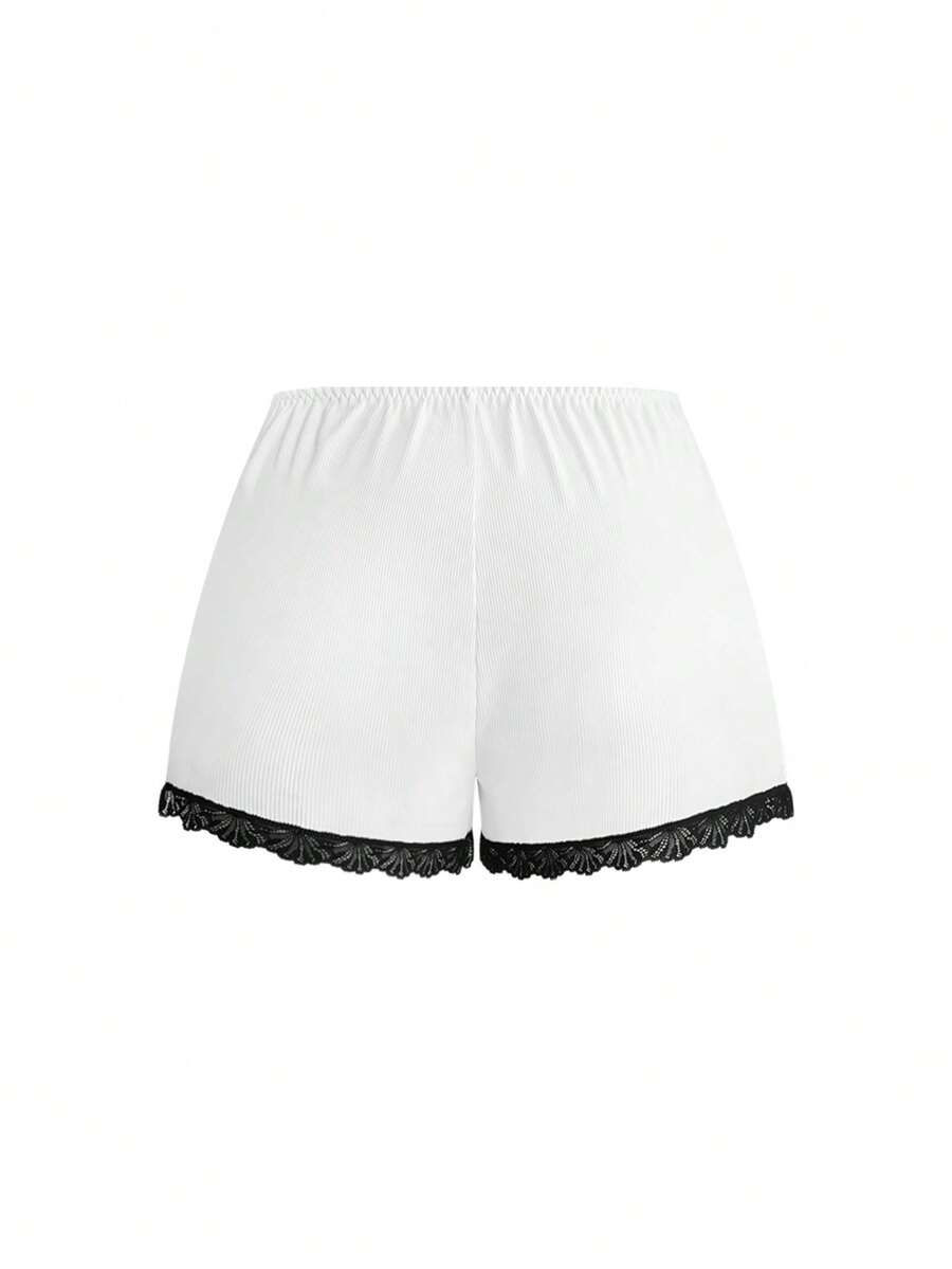 Two-piece ribbed pajama set featuring a lace-trimmed crop camisole top with spaghetti straps and matching shorts.