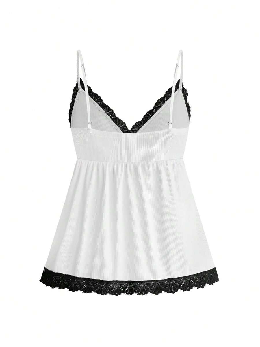 Two-piece ribbed pajama set featuring a lace-trimmed crop camisole top with spaghetti straps and matching shorts.