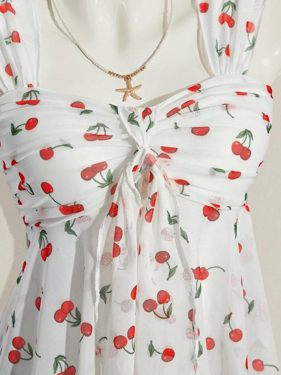 Women's white cherry print cami top with wide straps, ruched knot detail, and an asymmetrical hem