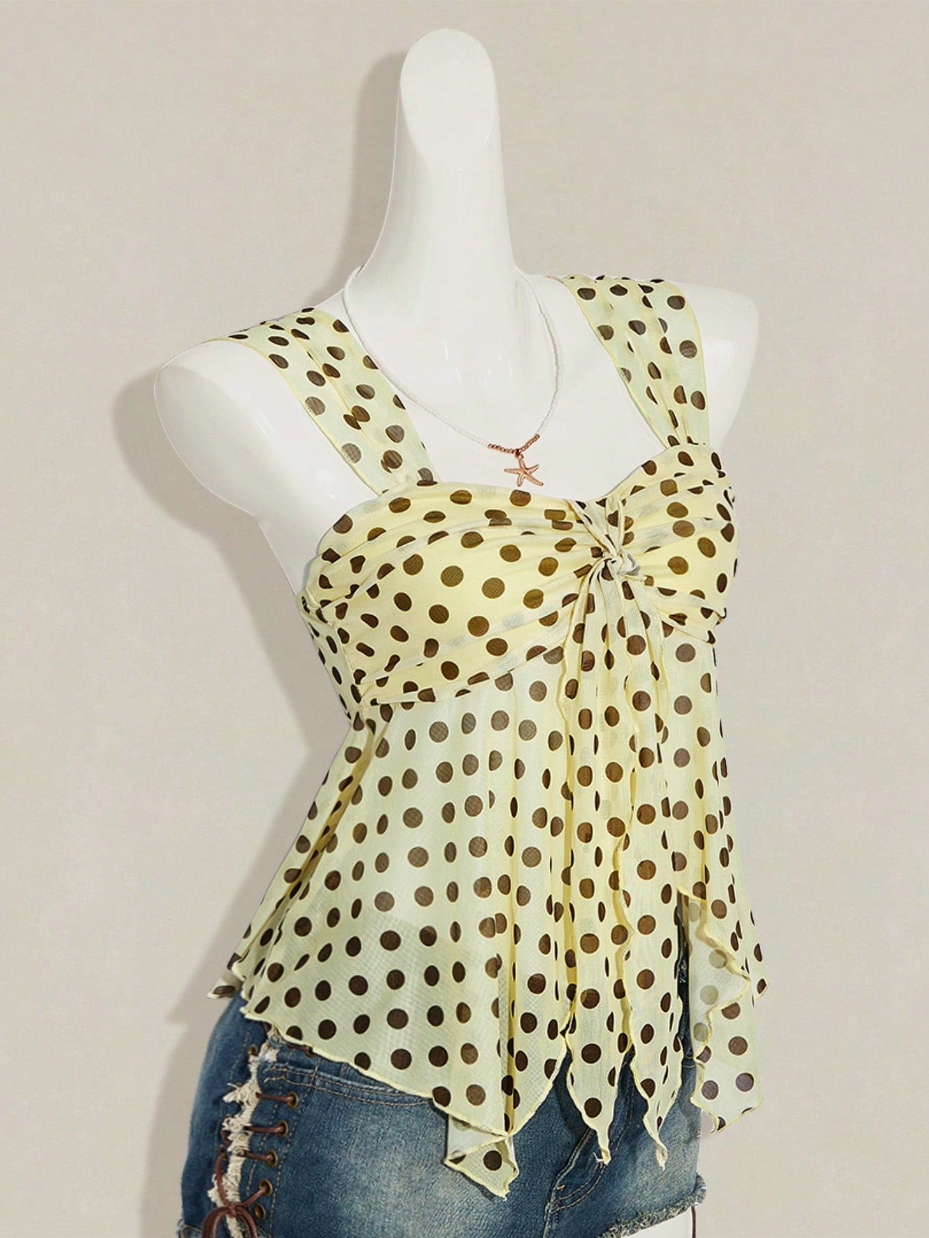 Women's white cherry print cami top with wide straps, ruched knot detail, and an asymmetrical hem