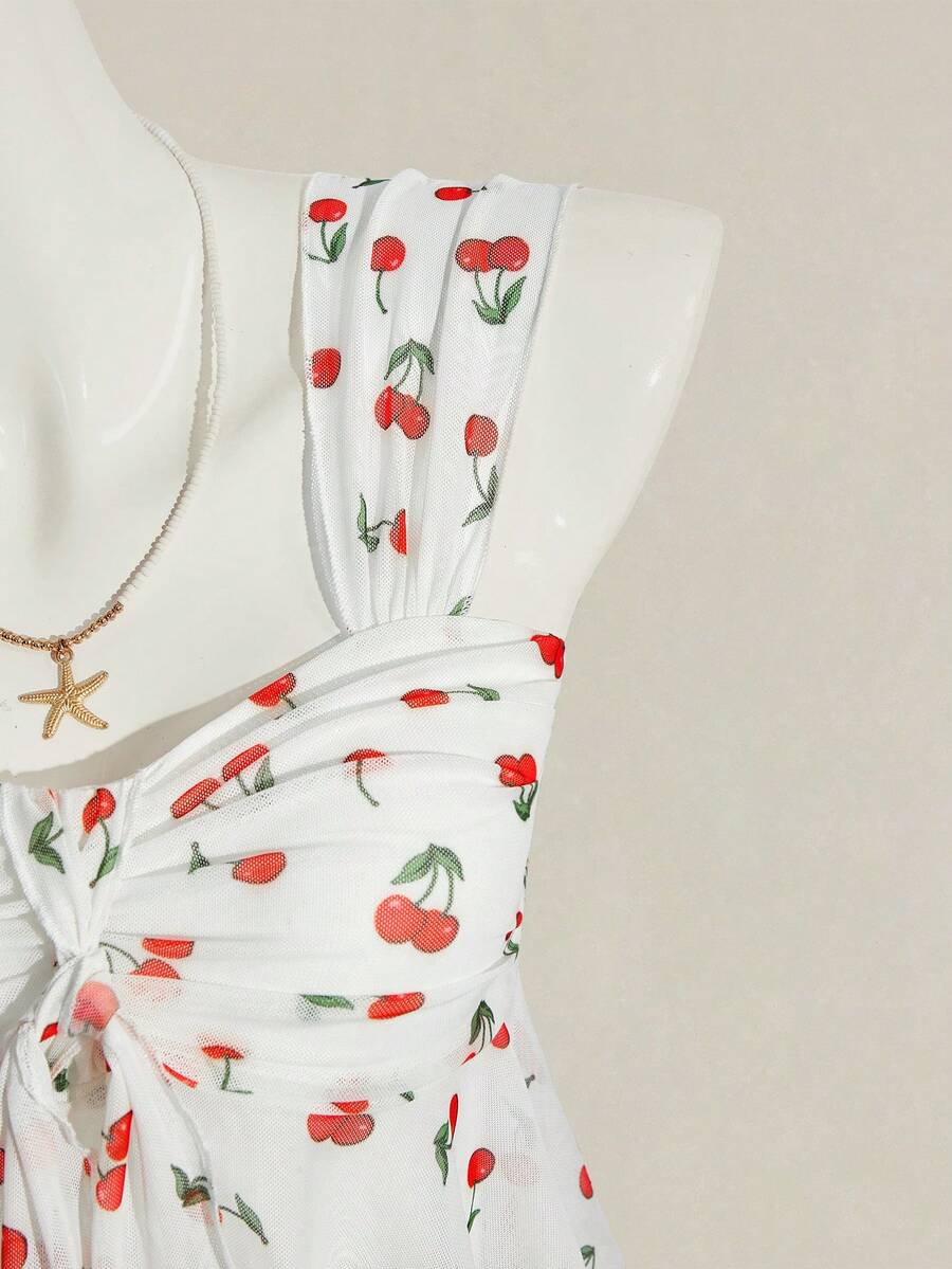 Women's white cherry print cami top with wide straps, ruched knot detail, and an asymmetrical hem