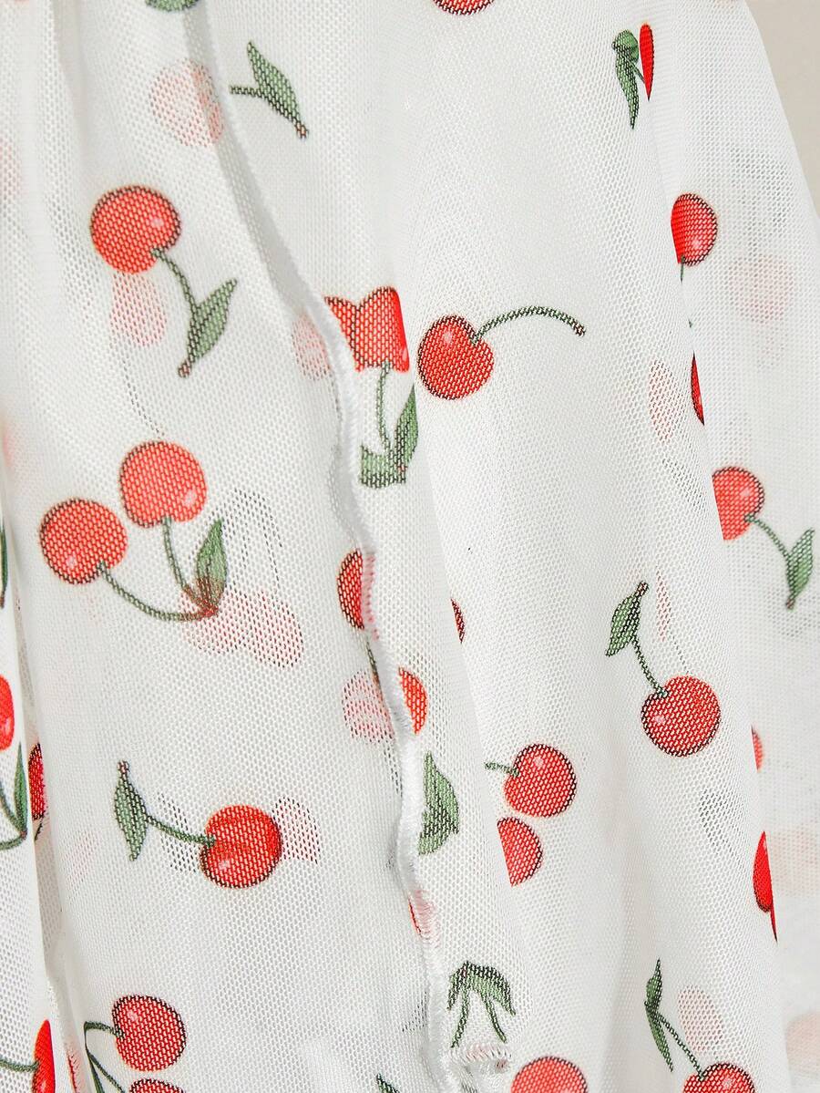 Women's white cherry print cami top with wide straps, ruched knot detail, and an asymmetrical hem