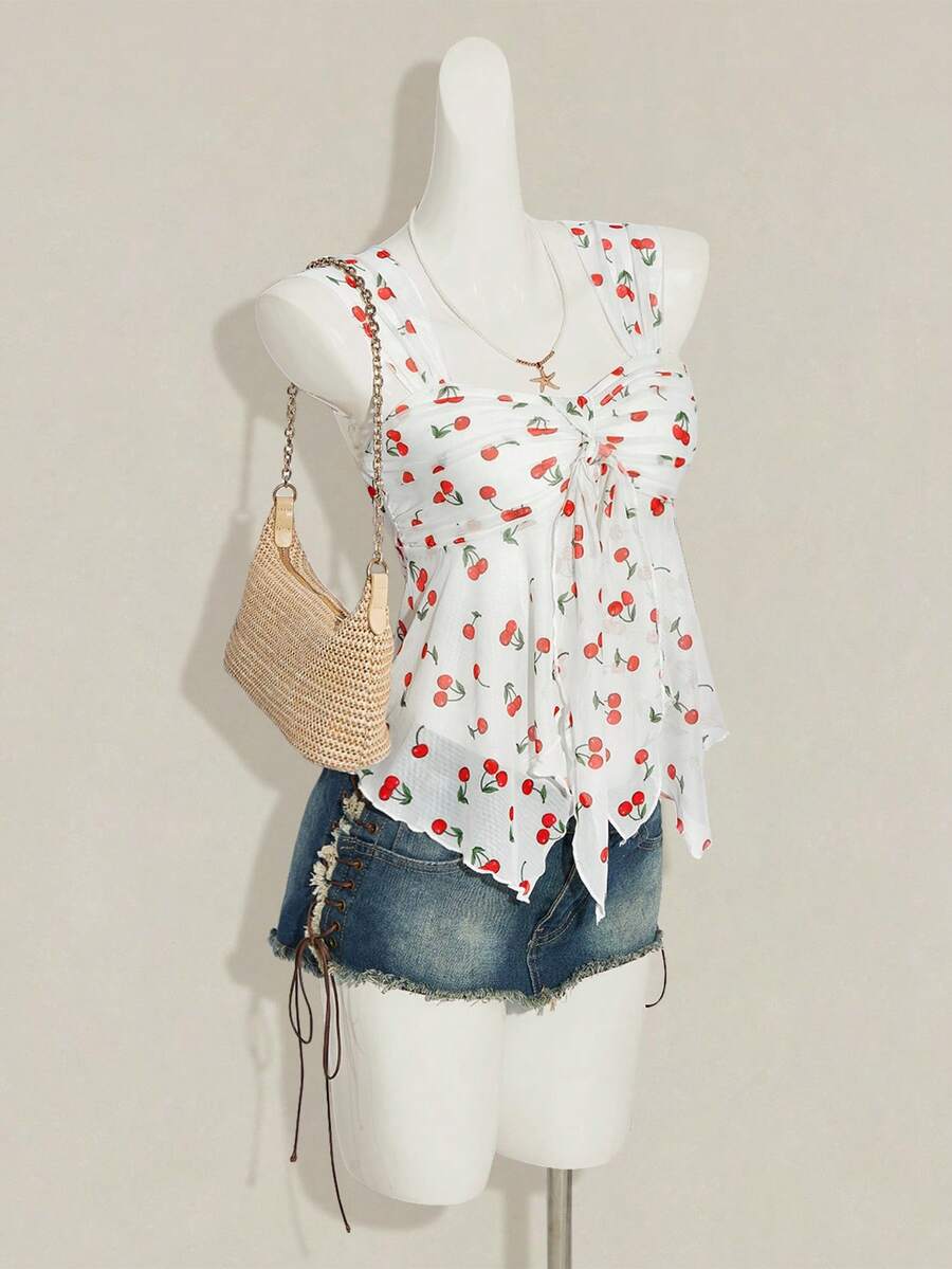 Women's white cherry print cami top with wide straps, ruched knot detail, and an asymmetrical hem