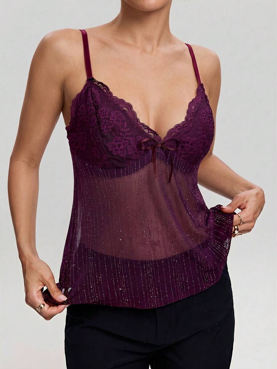 Women's backless spaghetti strap camisole top featuring contrast lace details, knot accents, and a slim fit.