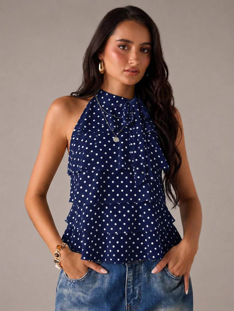 Women's sleeveless stand collar top in rib-knit fabric featuring button and hollow-out details.
