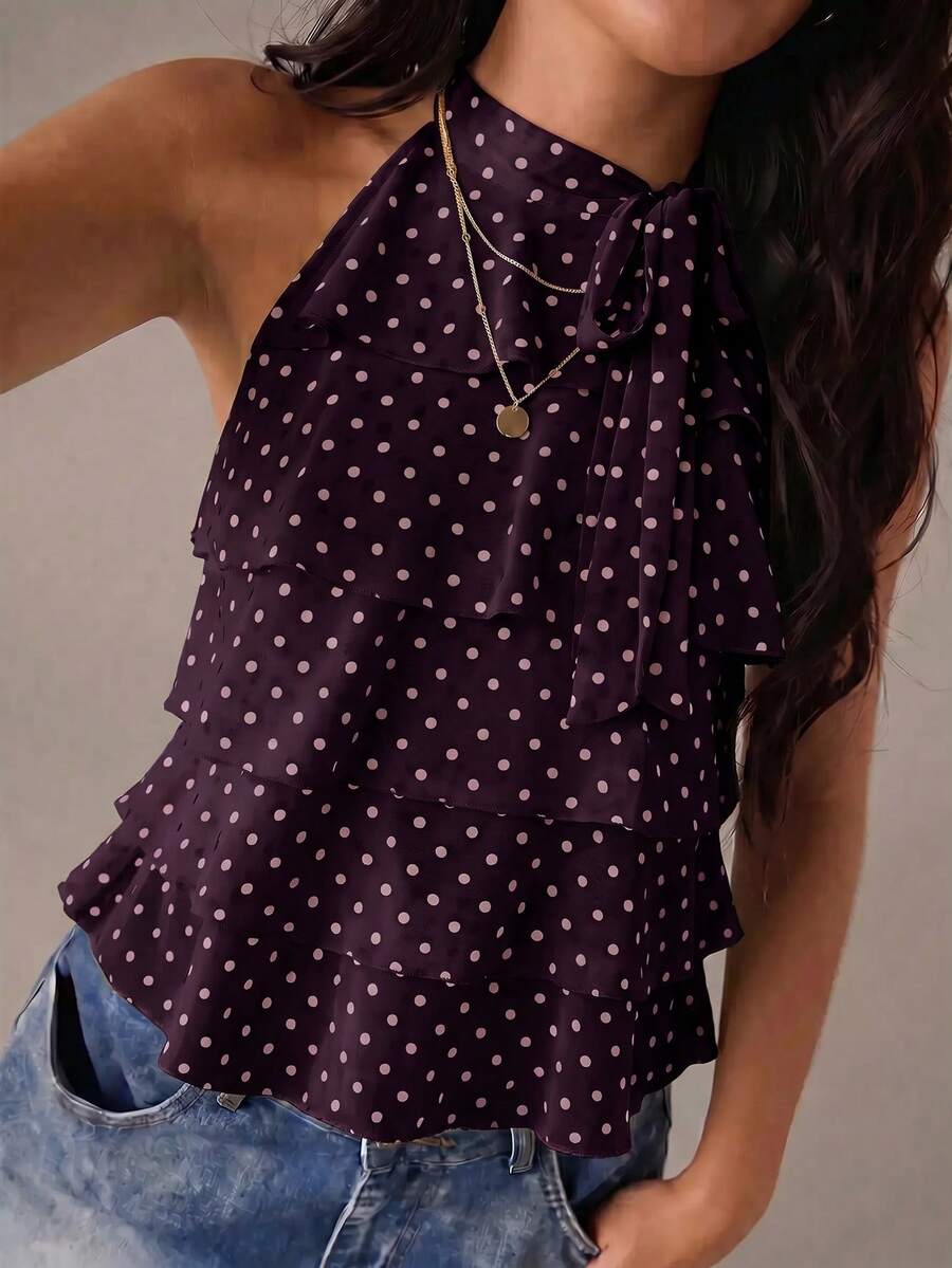 Women's sleeveless stand collar top in rib-knit fabric featuring button and hollow-out details.