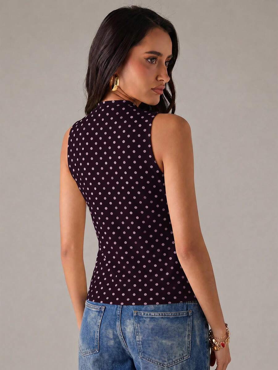 Women's sleeveless stand collar top in rib-knit fabric featuring button and hollow-out details.