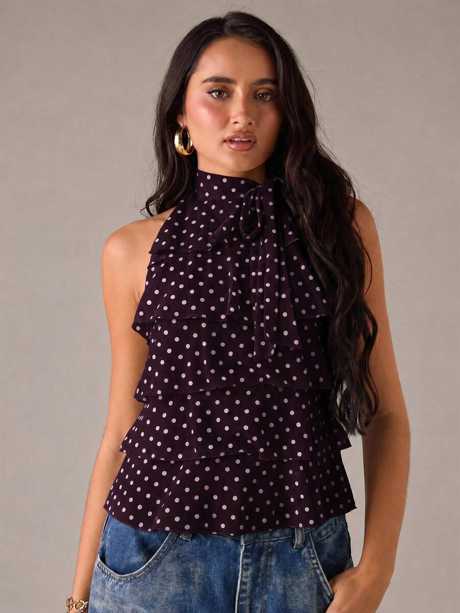 Women's sleeveless stand collar top in rib-knit fabric featuring button and hollow-out details.