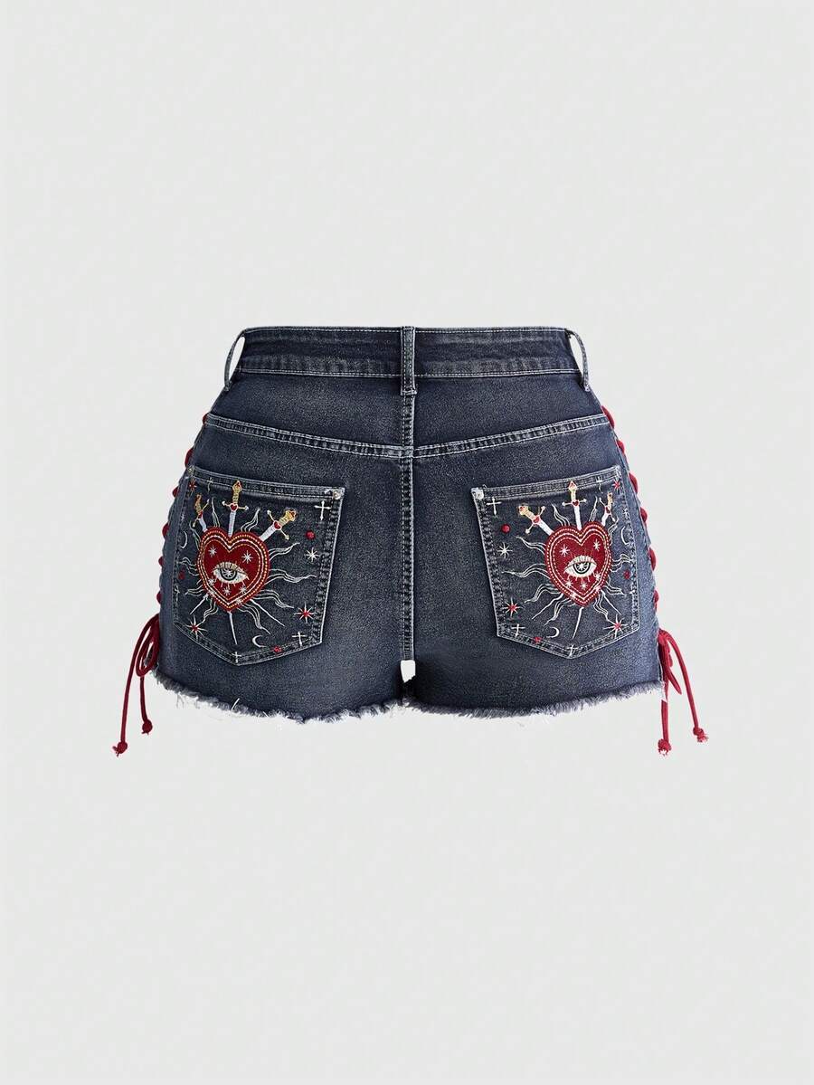 Plus size black gothic mini shorts with heart embroidery, graphic pocket pattern, lace-up detail, raw hem, and zipper fly