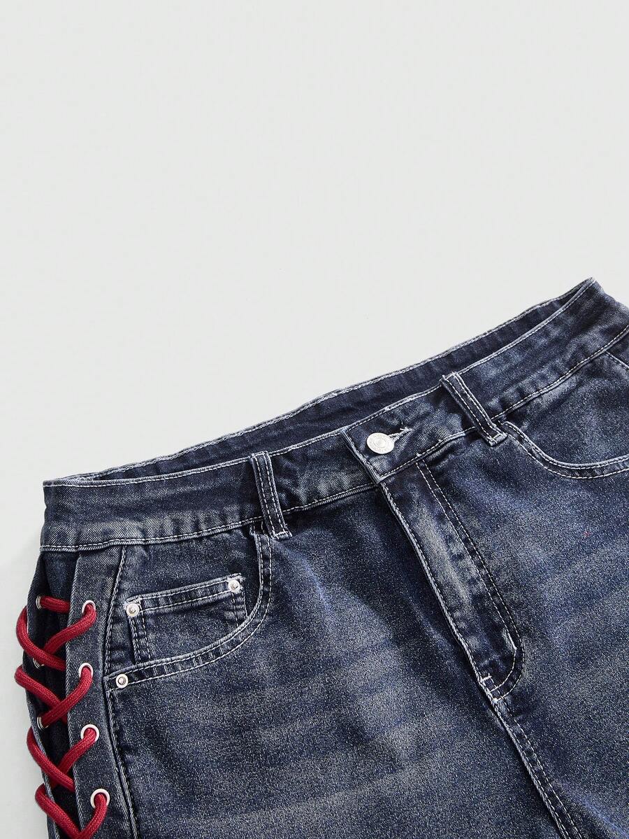 Plus size black gothic mini shorts with heart embroidery, graphic pocket pattern, lace-up detail, raw hem, and zipper fly