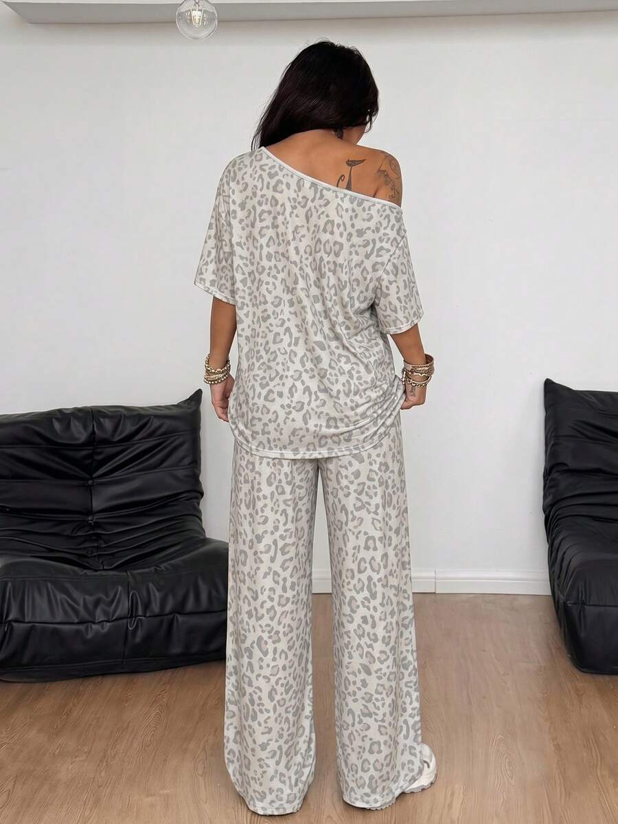 Women's two-piece outfit featuring an oversized asymmetrical neck t-shirt and matching wide-leg drawstring sweatpants.
