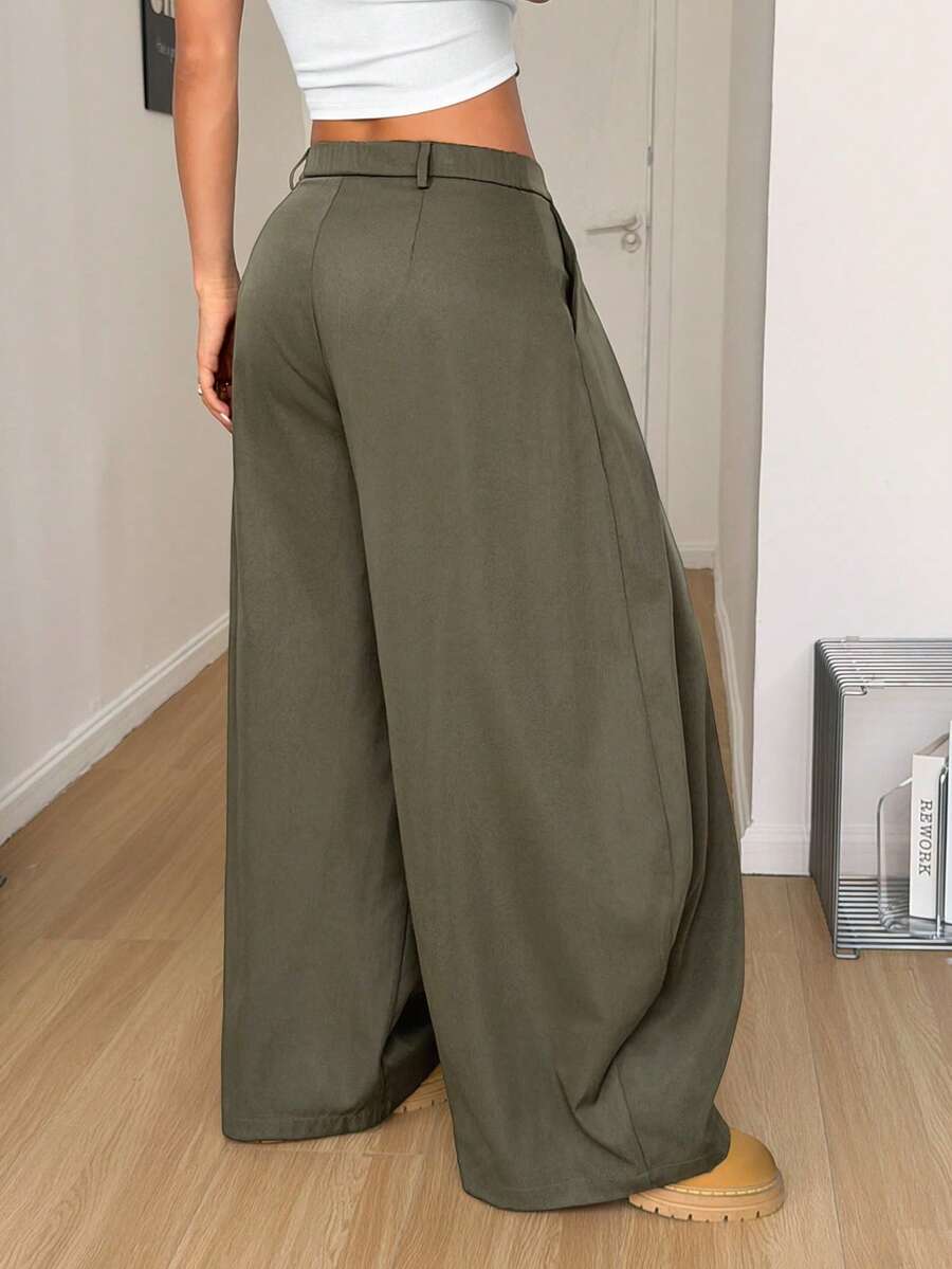 Women's army green baggy bloomer pants featuring a loose curved silhouette, low waist, functional pockets, and zipper fly closure.