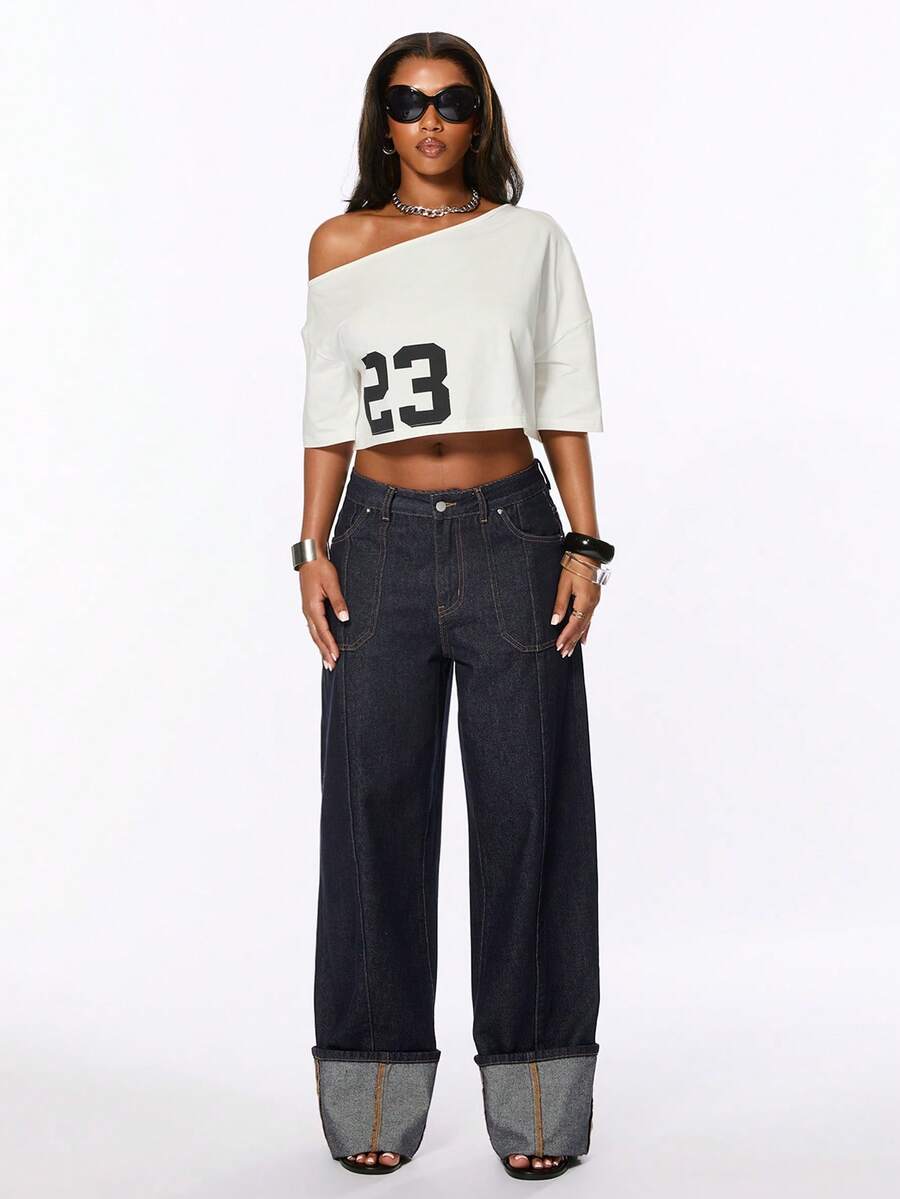 Front view of women's blue low waist flared denim jeans featuring a raw wash finish, loose straight leg fit, and zipper fly closure.