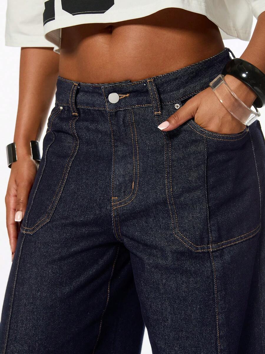 Front view of women's blue low waist flared denim jeans featuring a raw wash finish, loose straight leg fit, and zipper fly closure.
