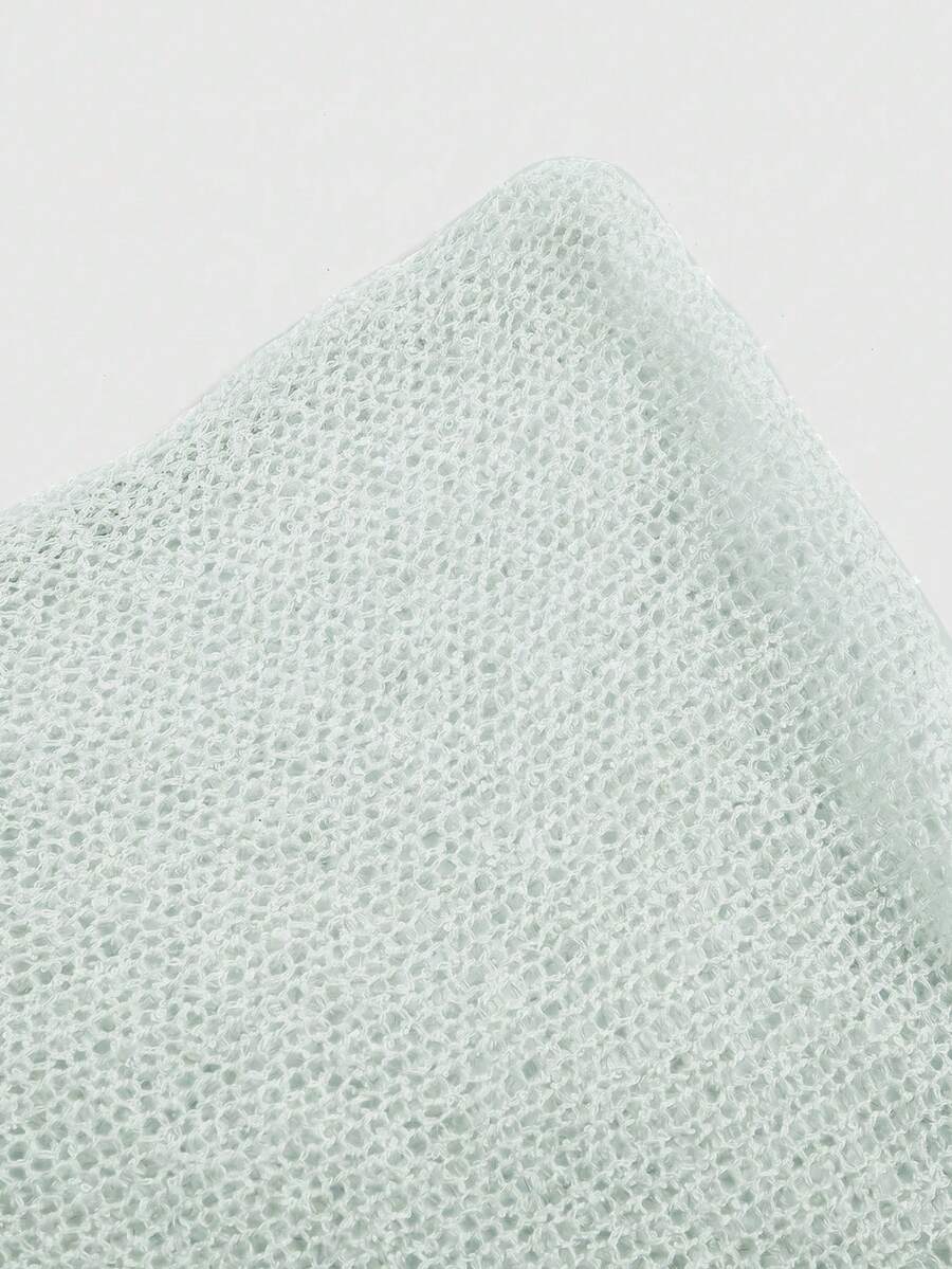 Women's casual hollow knit poncho top with boat neck, cloak sleeves, and asymmetrical hem