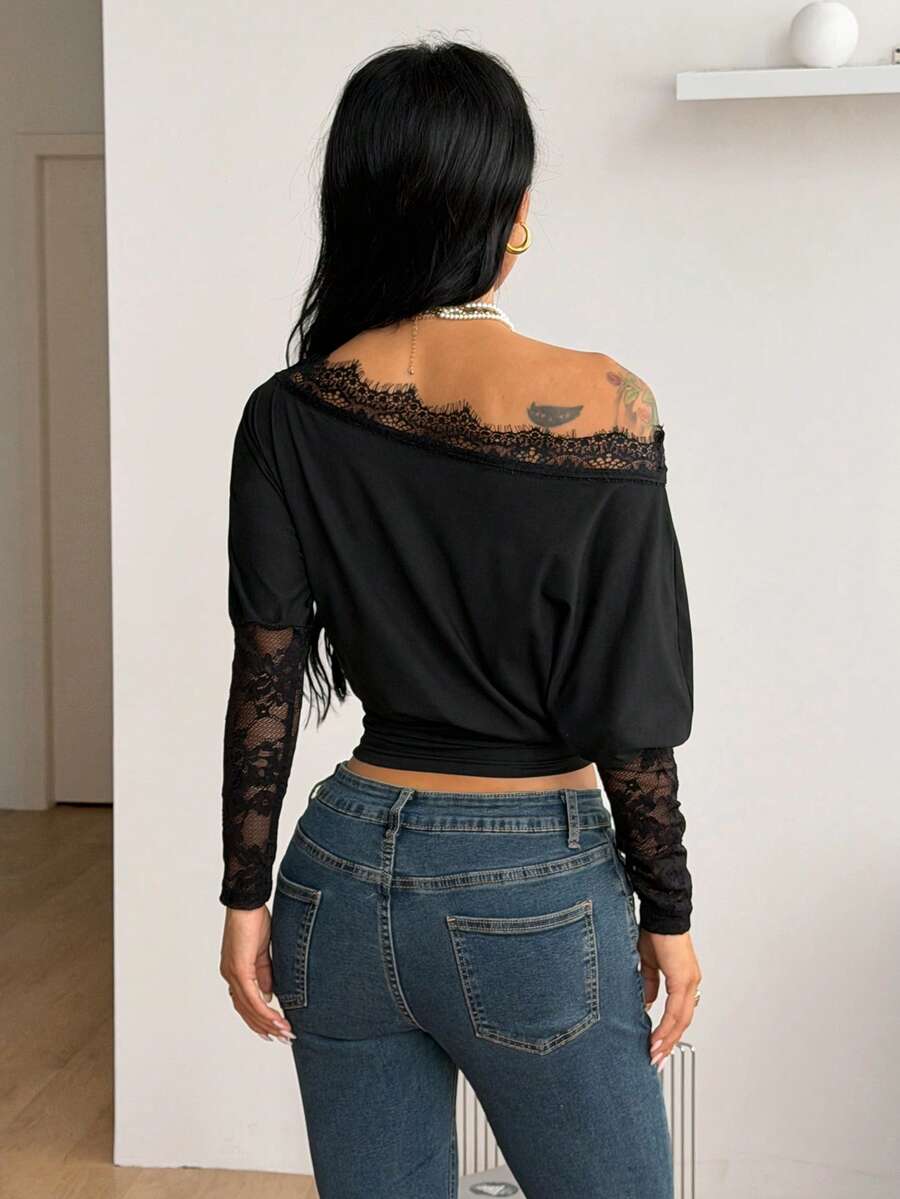 Women's black long sleeve t-shirt featuring delicate contrast lace details and a boat neckline in a knitted stretch fabric.