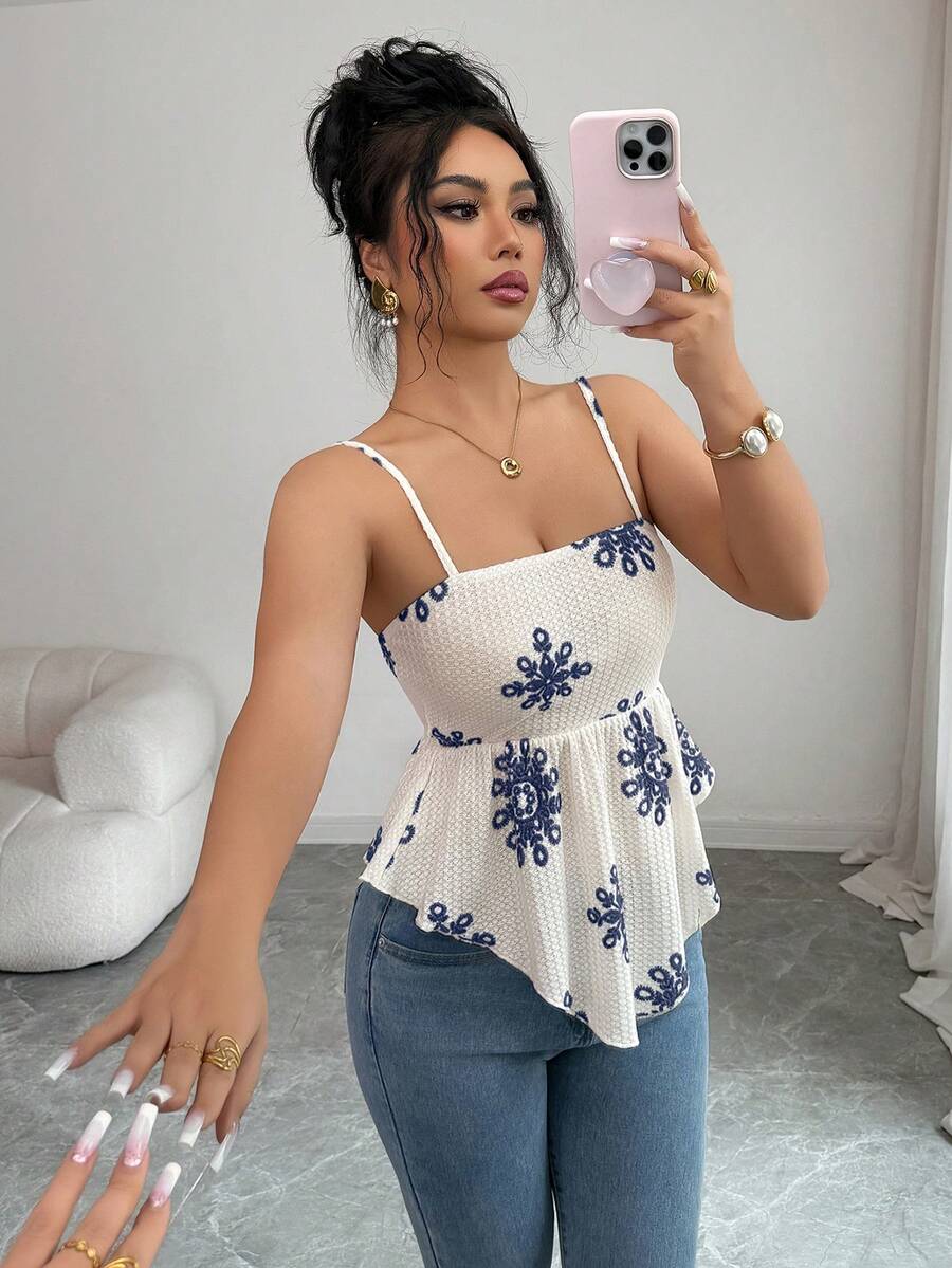 Women's floral snowflake print camisole top featuring spaghetti straps, slim fit, and an asymmetrical hem in navy blue knit fabric.