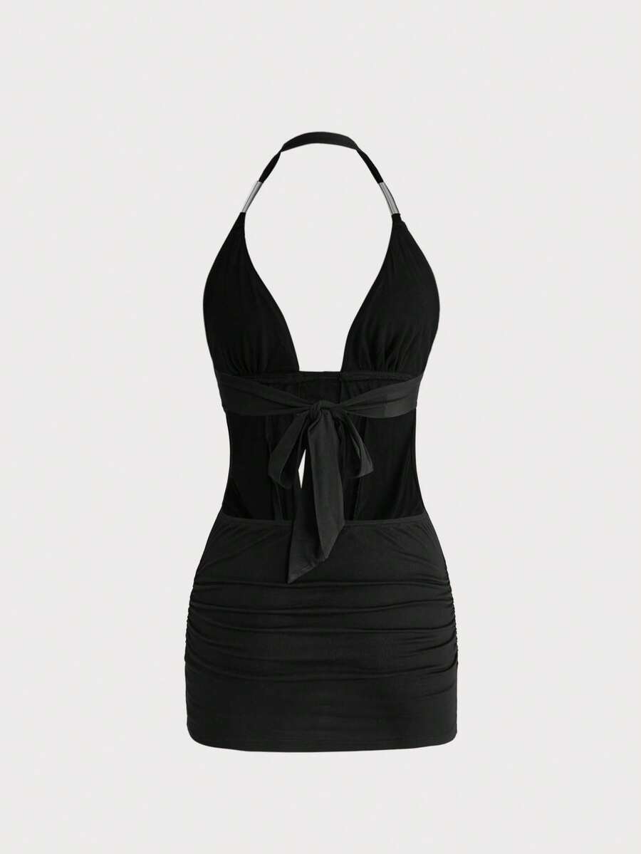 Women's slim fit halter neck bodycon mini dress featuring a backless design with knot tie back details.