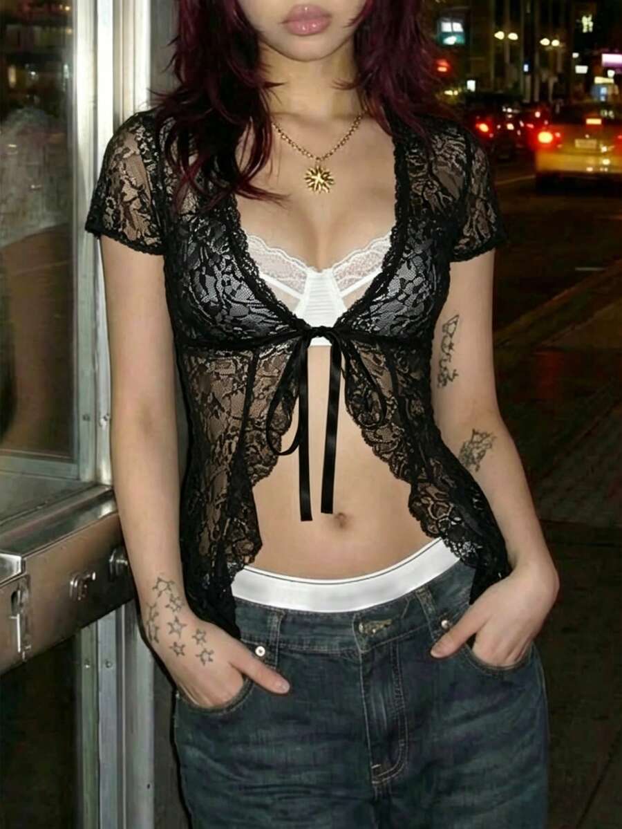 Women's semi-sheer deep V-neck top featuring cap sleeves, contrast lace trimming, and a lace-up front detail.