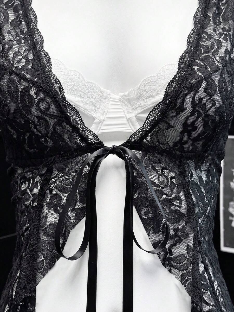 Women's semi-sheer deep V-neck top featuring cap sleeves, contrast lace trimming, and a lace-up front detail.