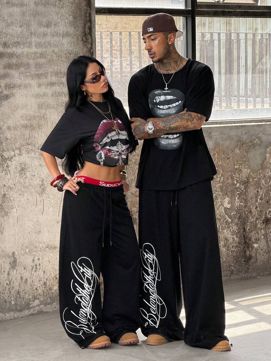 Women's loose fit wide leg graphic sweatpants in light grey with an elastic drawstring waistband