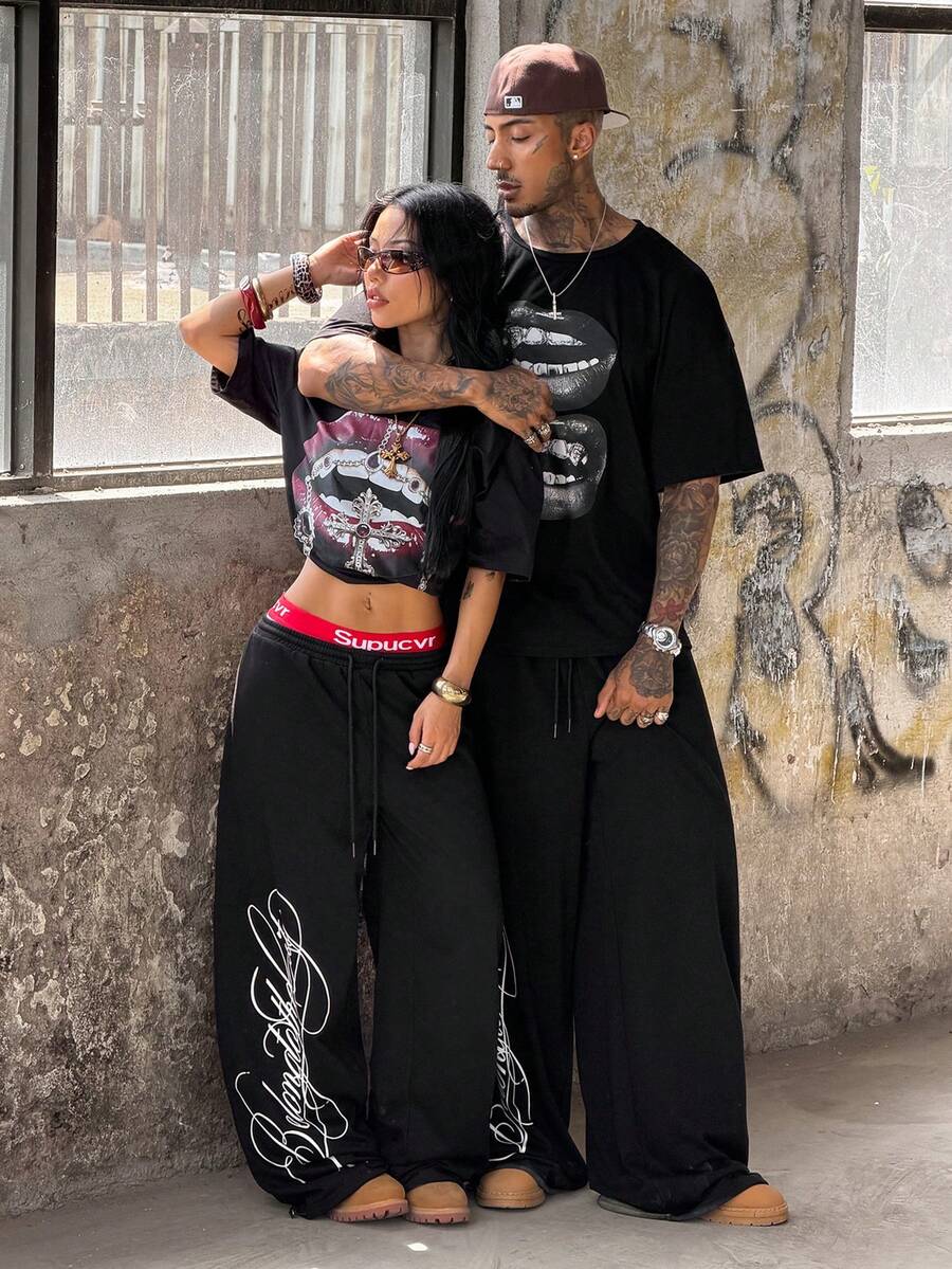 Women's loose fit wide leg graphic sweatpants in light grey with an elastic drawstring waistband