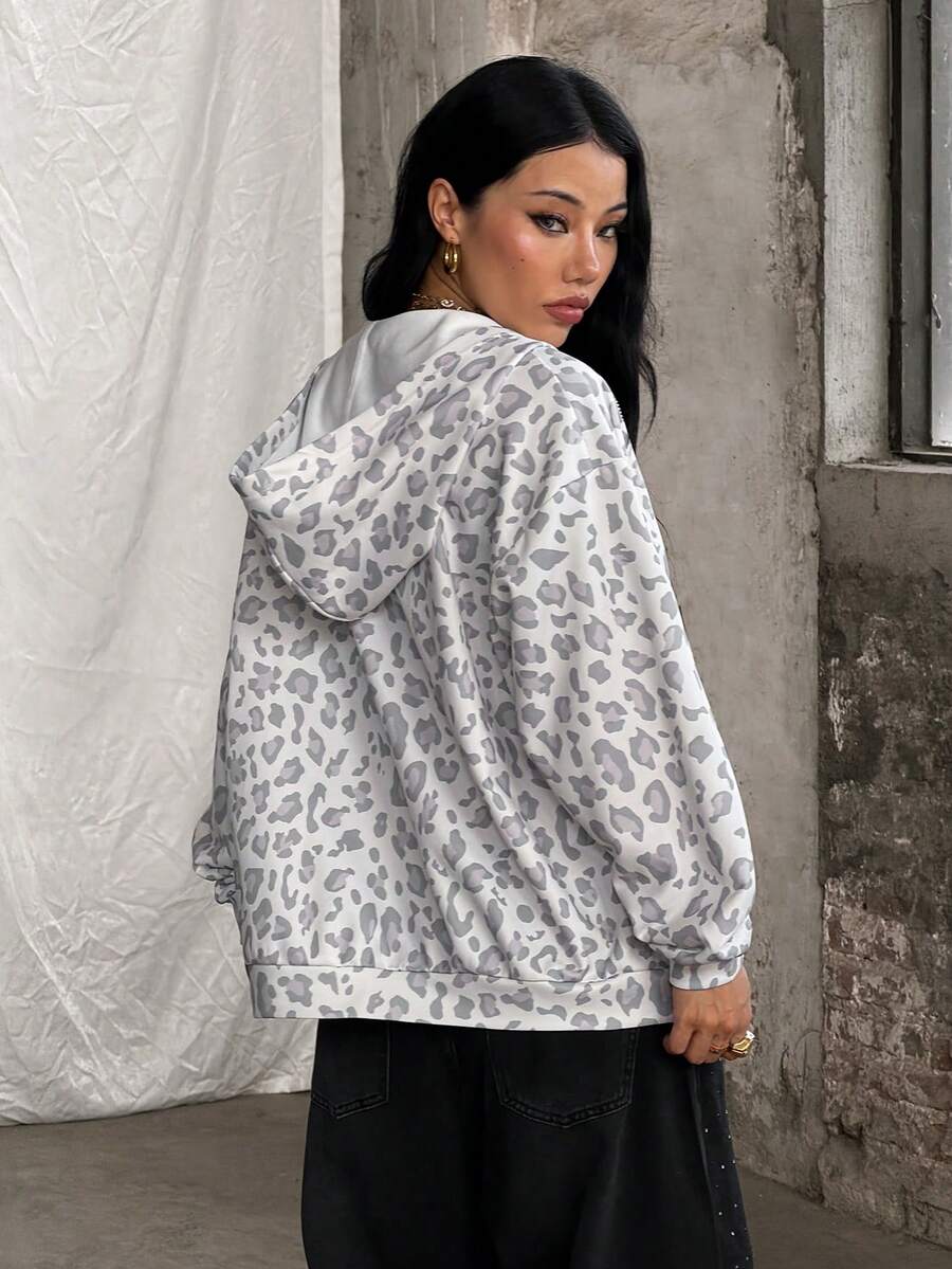 Women's army green camo zip up hoodie with drop shoulder sleeves, front pockets, and drawstring hood