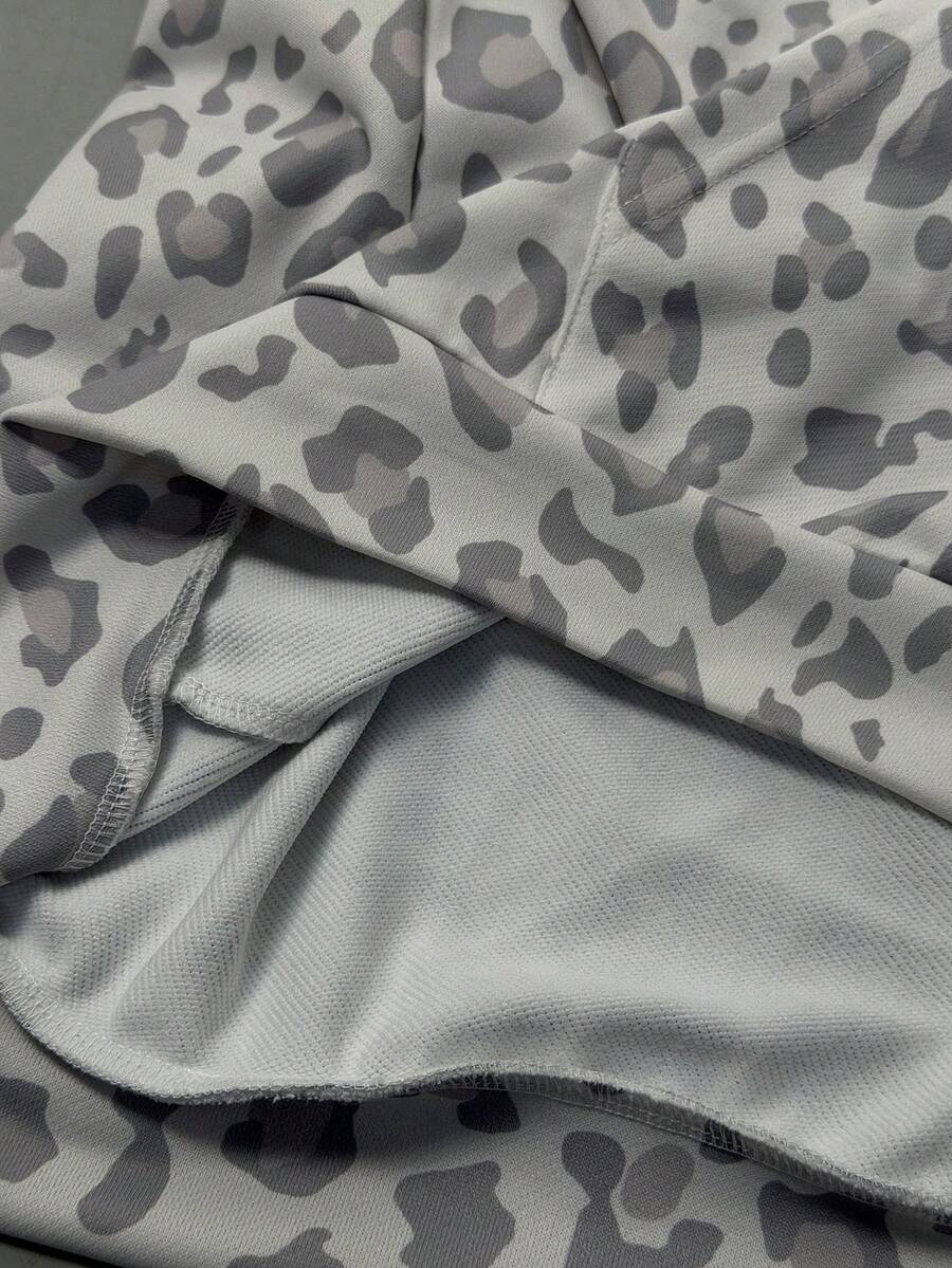 Women's army green camo zip up hoodie with drop shoulder sleeves, front pockets, and drawstring hood