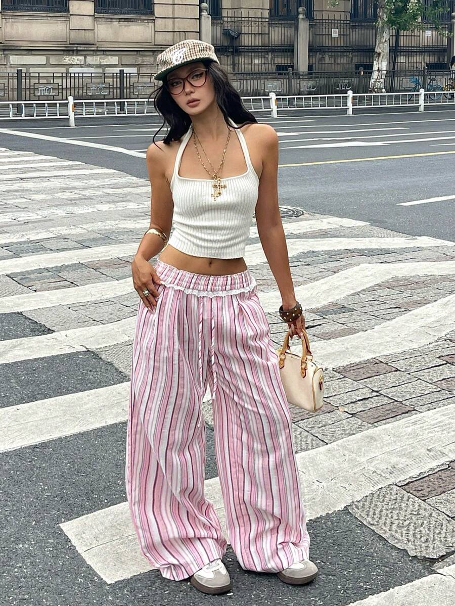 Women's loose fit brown and tan plaid wide leg pants featuring an elastic drawstring waist and side pockets.