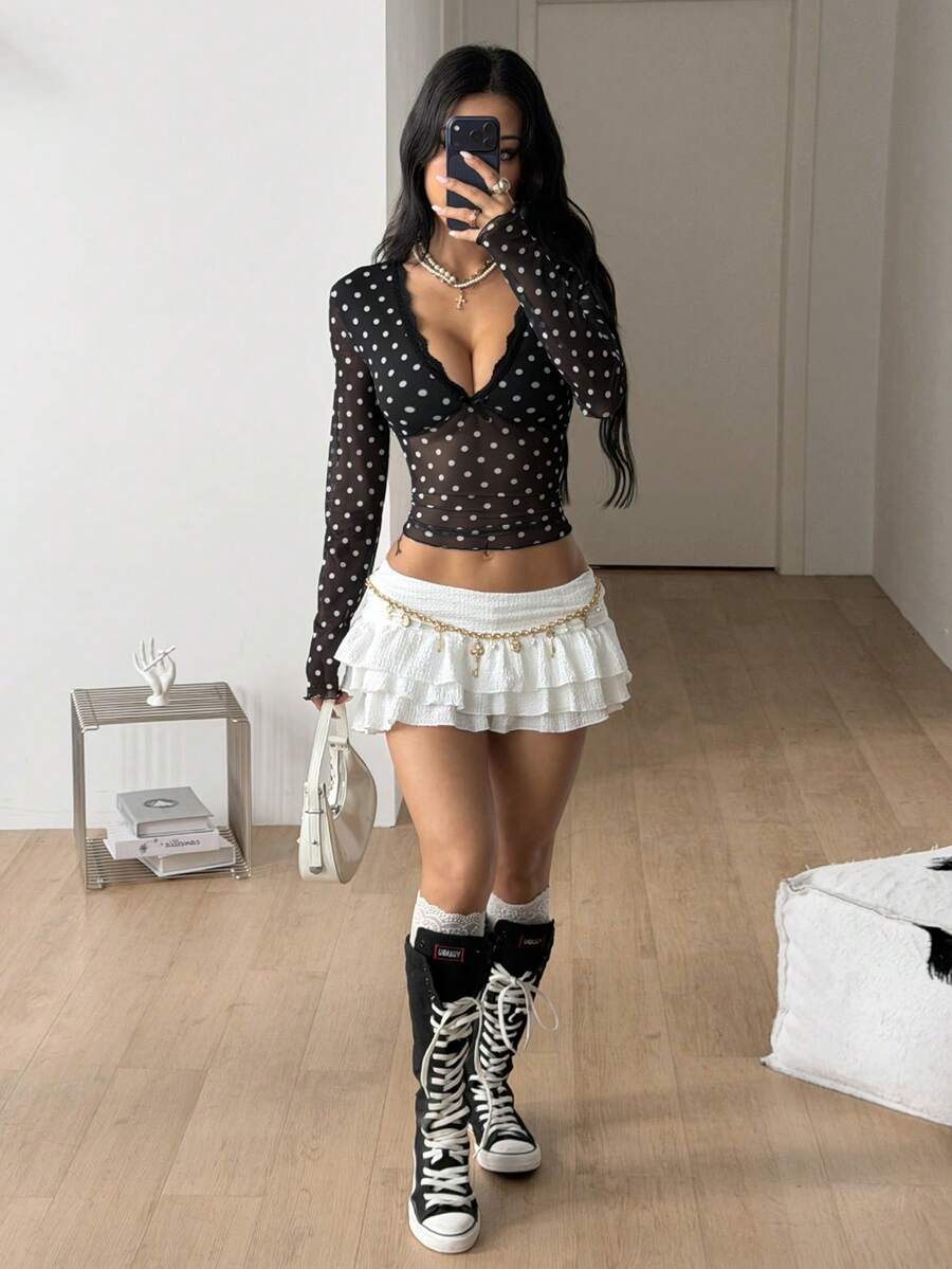 Women's polka dot sheer mesh crop blouse featuring contrast scallop lace trim along the V-neckline and long sleeves in a slim fit silhouette.