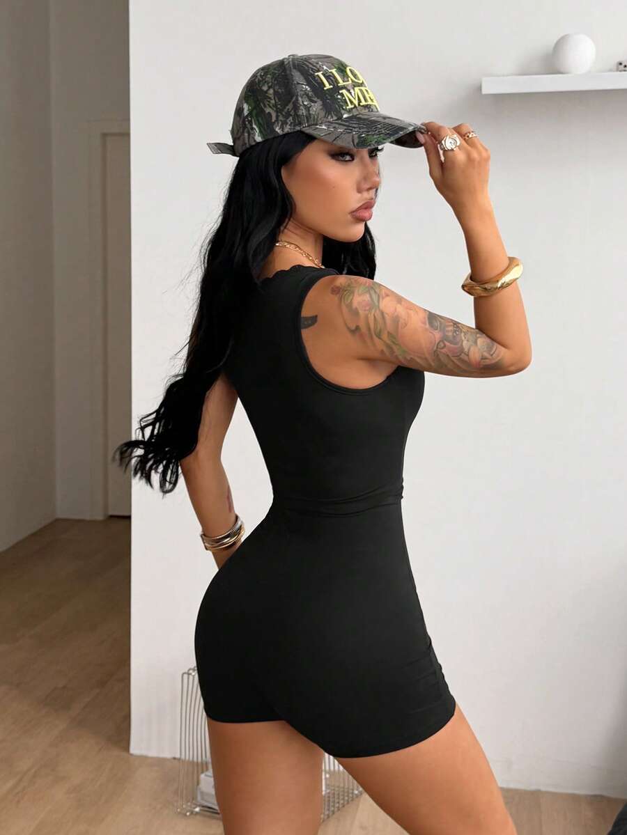 Women's black sleeveless unitard romper with a square neckline and backless design in stretchy knitted fabric.