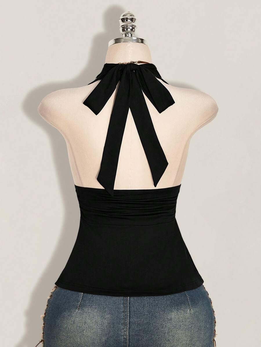 Women's backless halter babydoll tank top featuring a square neckline, slim fit silhouette, and a flared ruffle hem.