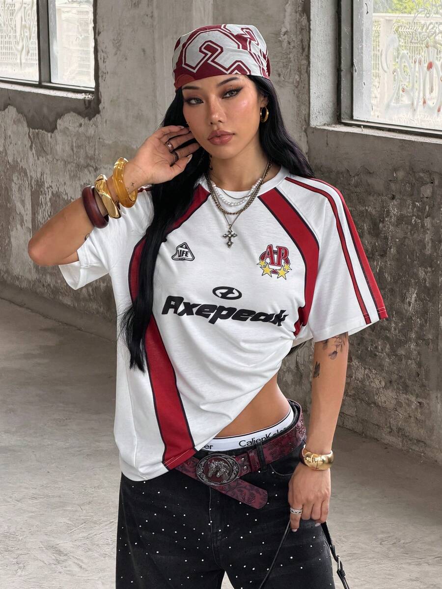 Yellow oversized graphic t-shirt featuring Brazil letter print on the front with contrast raglan sleeves and side stripe detailing.