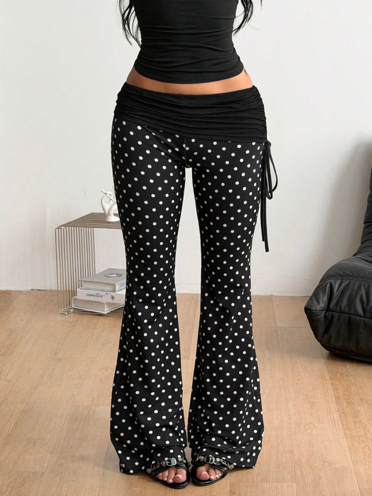Women's black and white polka dot flare leg pants with side drawstring and ruched details