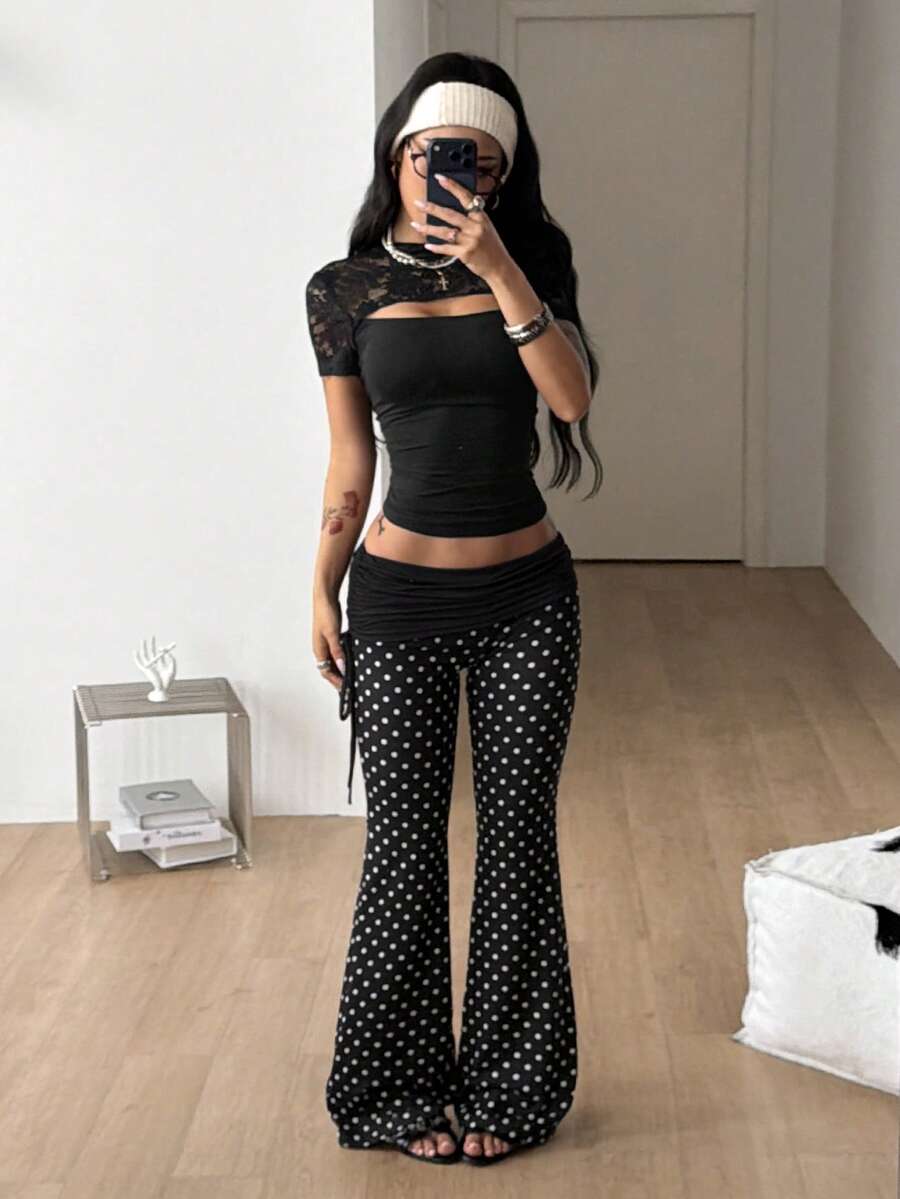 Women's black and white polka dot flare leg pants with side drawstring and ruched details