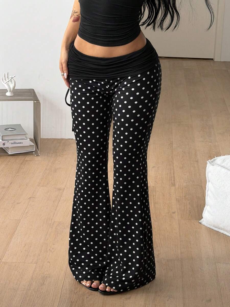 Women's black and white polka dot flare leg pants with side drawstring and ruched details