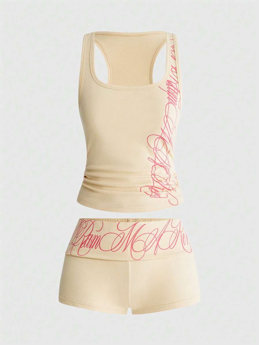 Punk-inspired two-piece set with a fitted scoop neck slogan tank top featuring cross and rhinestone details paired with ultra low waist mini shorts.