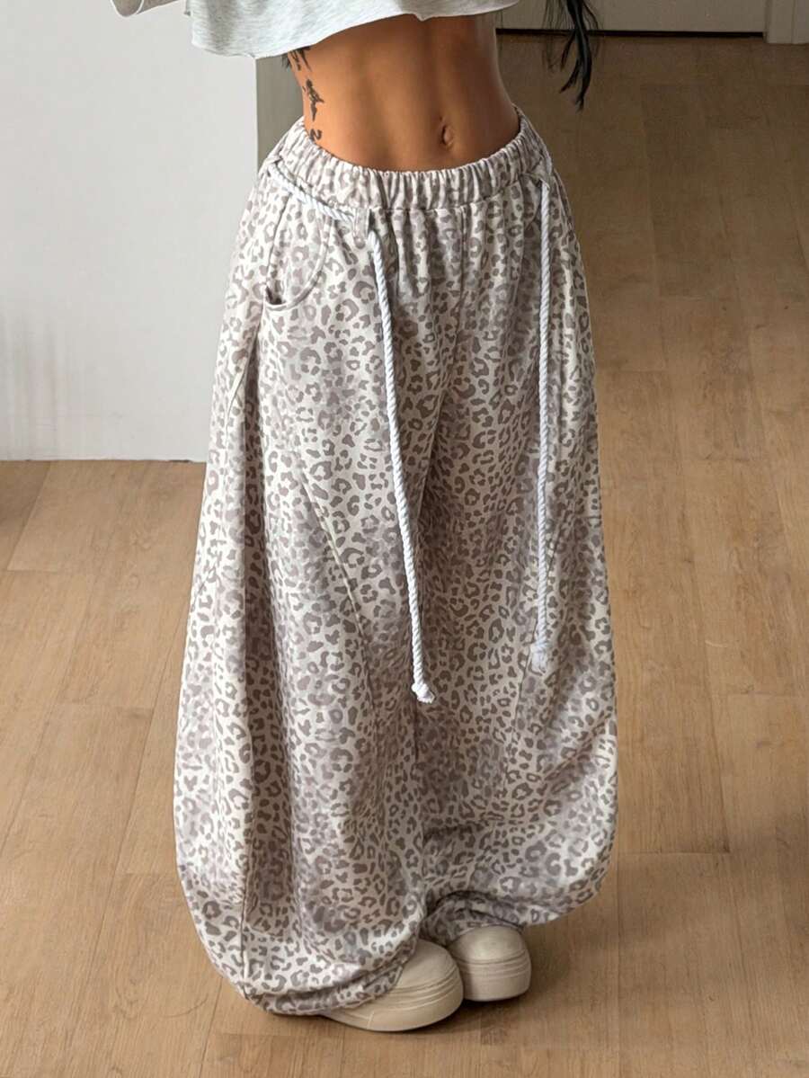 Women's casual grey plaid sweatpants featuring an elastic drawstring waistband, side pockets, and a relaxed loose fit.
