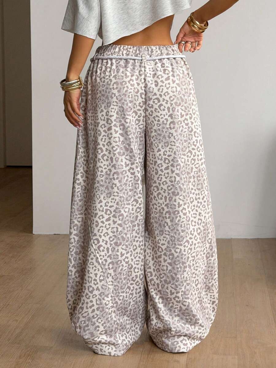 Women's casual grey plaid sweatpants featuring an elastic drawstring waistband, side pockets, and a relaxed loose fit.
