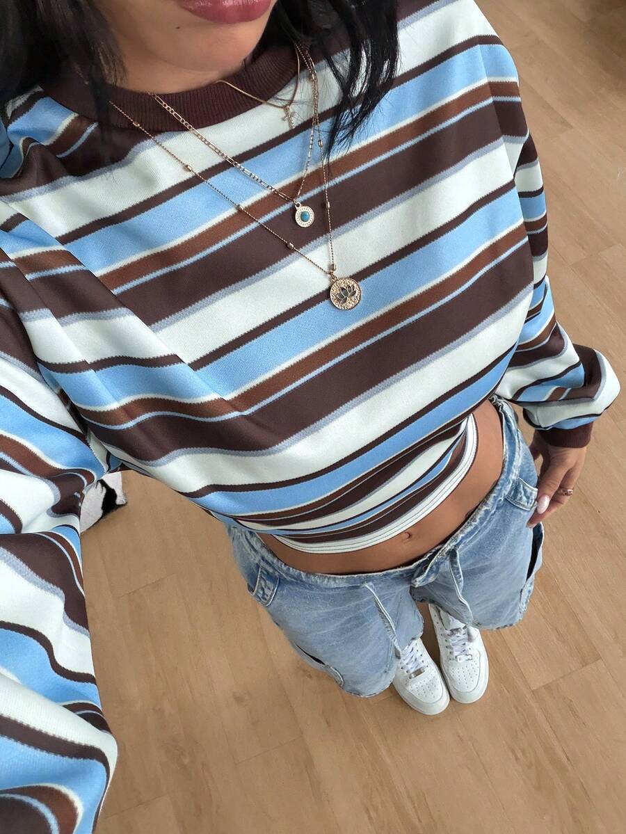Women's striped pullover sweatshirt featuring drop shoulder long sleeves and a classic round neckline.