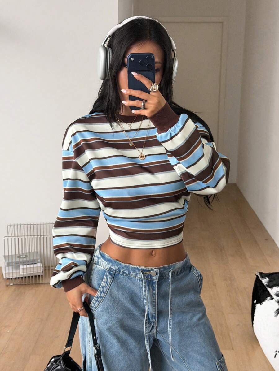 Women's striped pullover sweatshirt featuring drop shoulder long sleeves and a classic round neckline.