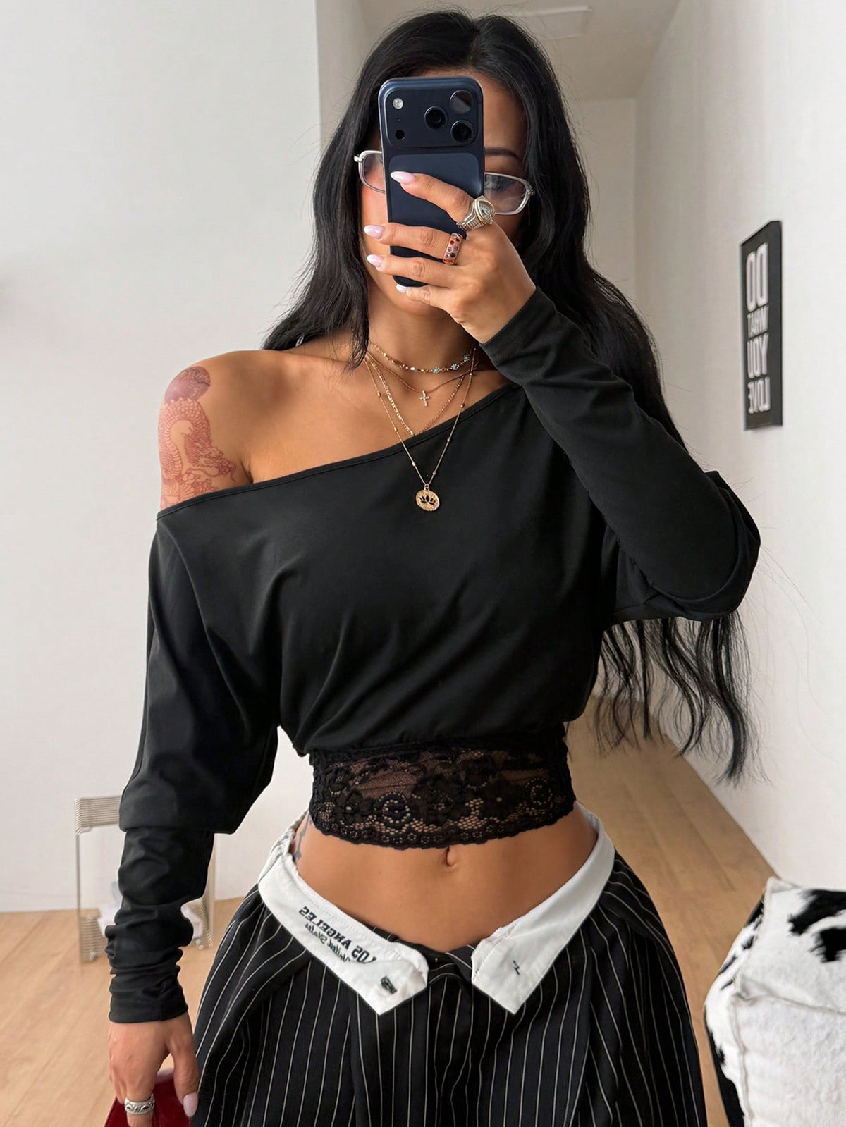 Women's black long sleeve t-shirt featuring delicate contrast lace details and a boat neckline in a knitted stretch fabric.