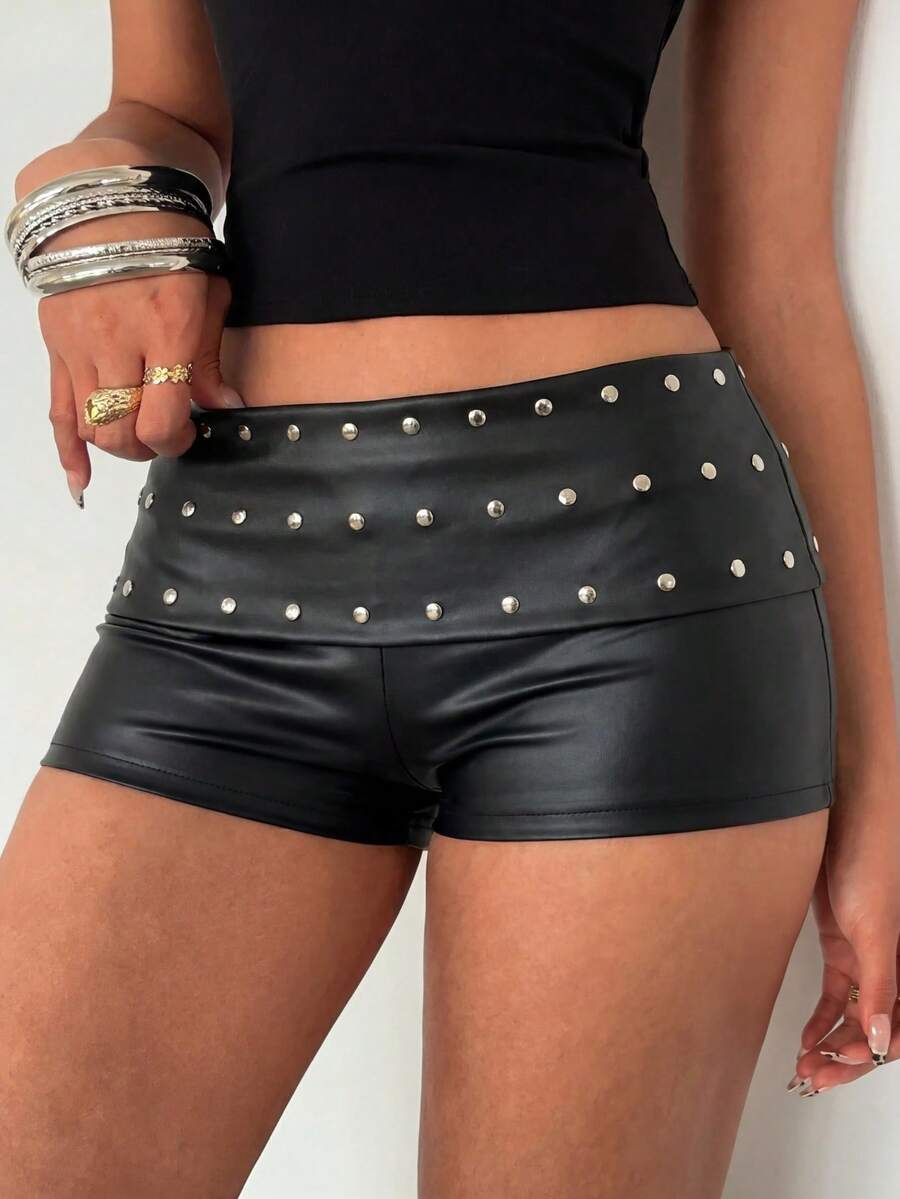 Women's studded PU ultra low waist mini shorts with zipper fly closure, skinny fit, mini length, and plain unlined design.