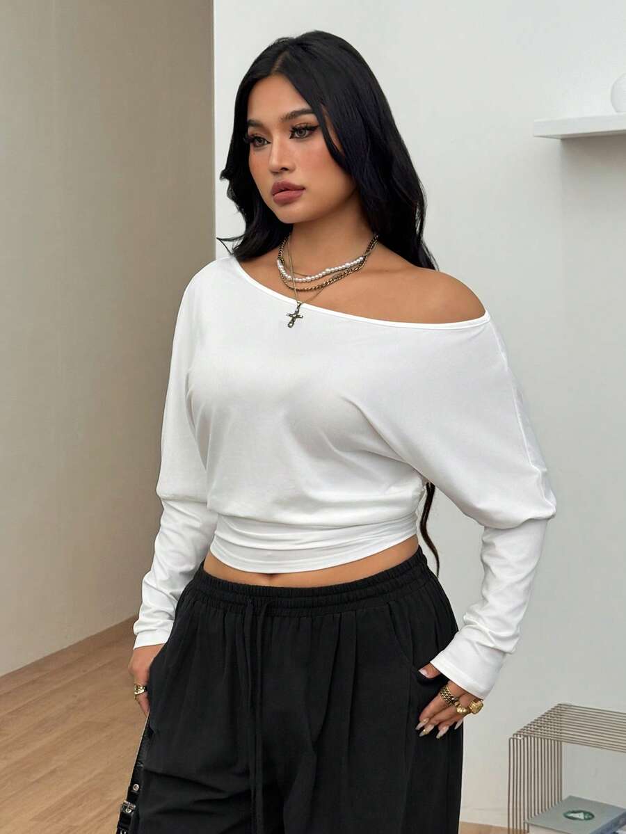 Women's black asymmetrical neck t-shirt featuring batwing sleeves and a slim fit knitted design.