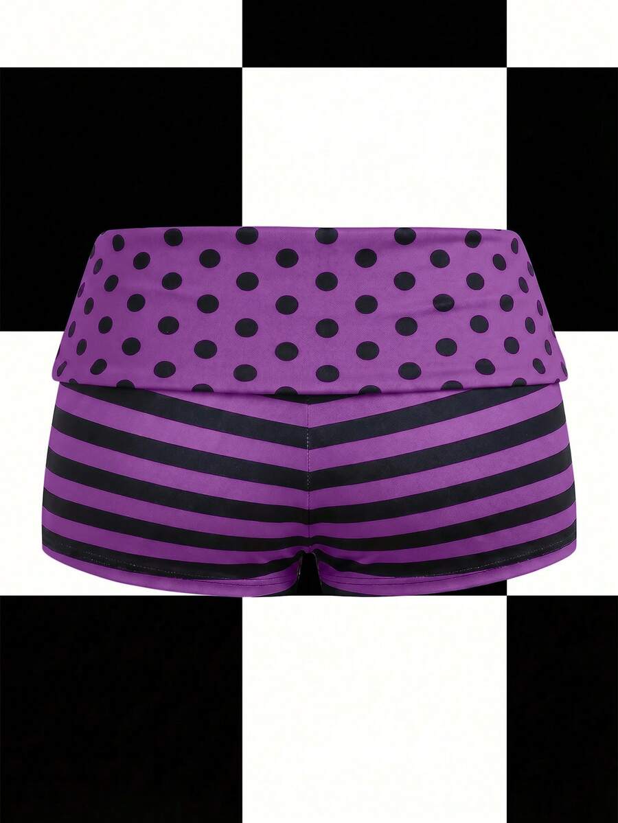Women's black low waist mini track shorts with contrast polka dot, striped, geometric, and plant-inspired print details, elastic waistband, and skinny fit