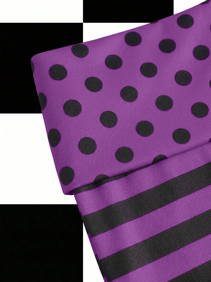 Women's black low waist mini track shorts with contrast polka dot, striped, geometric, and plant-inspired print details, elastic waistband, and skinny fit