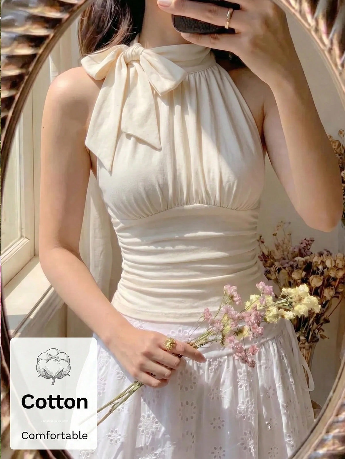 Women's sleeveless high-neck halter crop top in apricot with ruched knot front detailing.