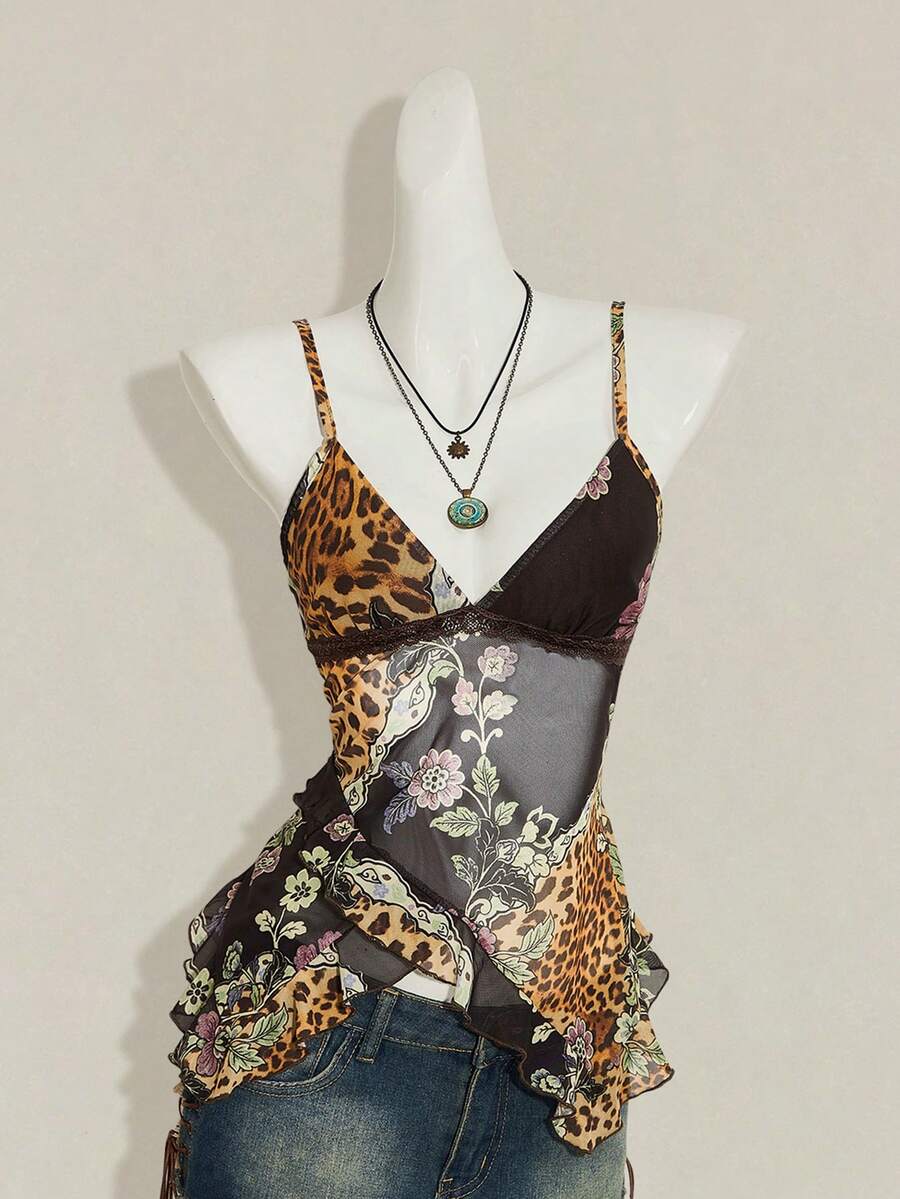 Women's graphic print camisole top featuring thin spaghetti straps, a backless cut, and an asymmetrical hem.