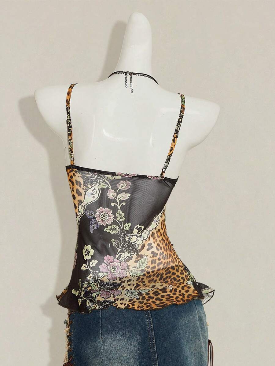 Women's graphic print camisole top featuring thin spaghetti straps, a backless cut, and an asymmetrical hem.